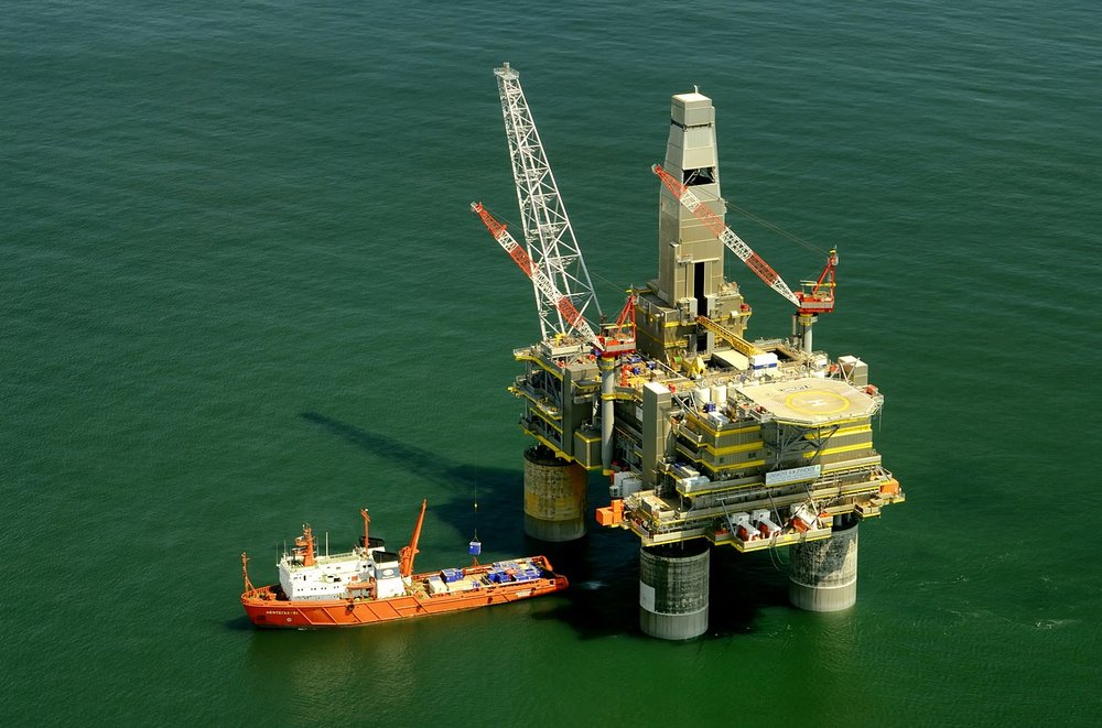 Offshore oil rig and oil tanker on water